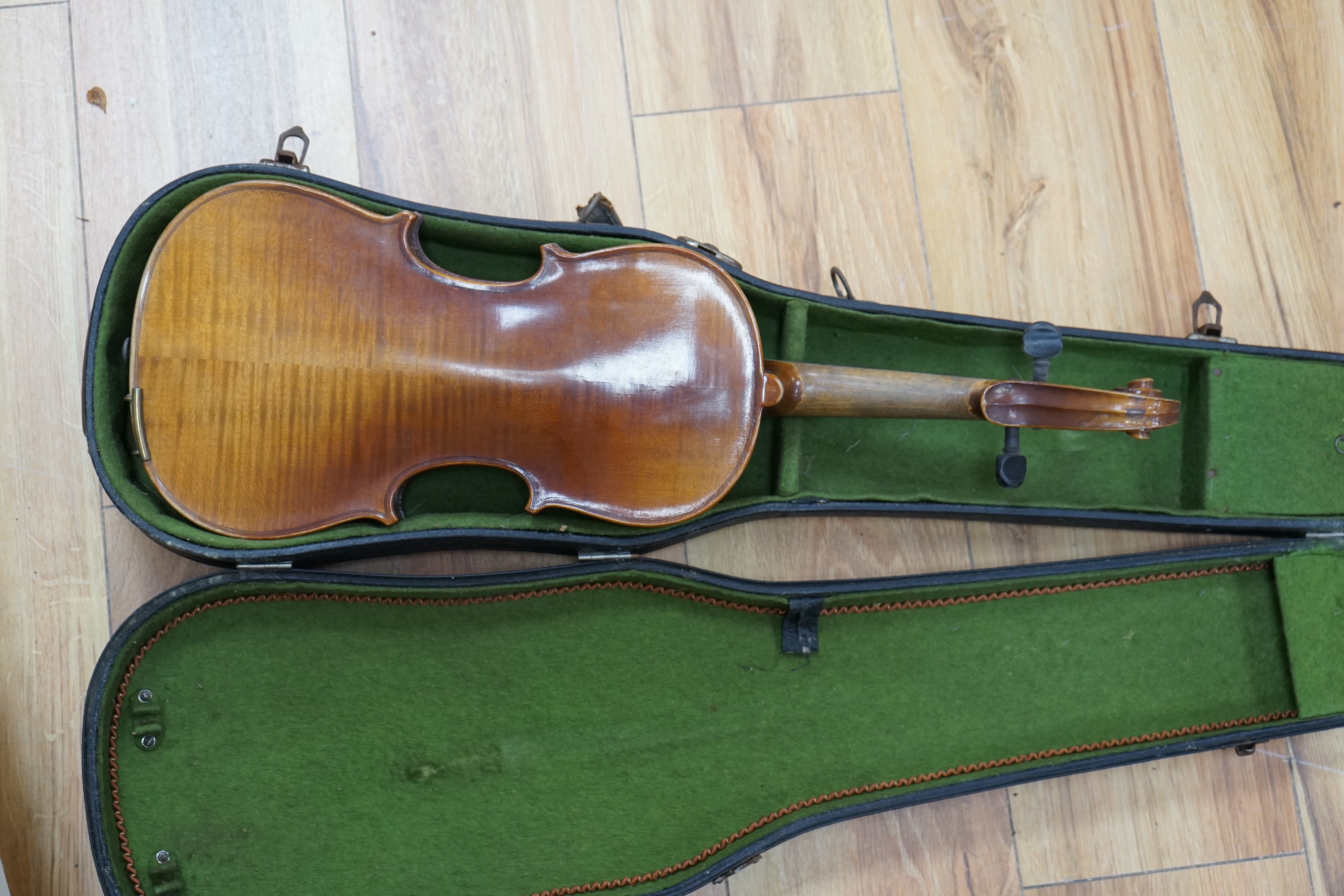 A cased three-quarter size 1920s Czechoslovakian violin, body length 33cm. Condition - fair to good.